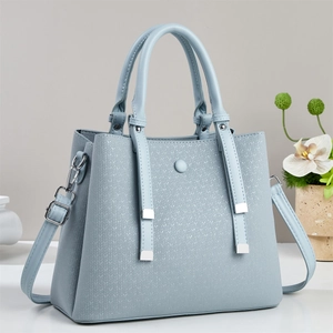 Light blue faux leather handbag with woven texture and adjustable strap for winter 2025