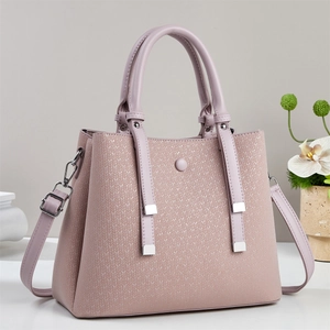 Close-up of pink winter tote bag with textured surface and adjustable shoulder strap
