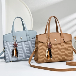 Close-up of woven texture detail and heart metal buckle on chic commuter tote bags