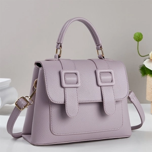 Minimalist lavender pebbled leather satchel handbag shown from a front-side angle