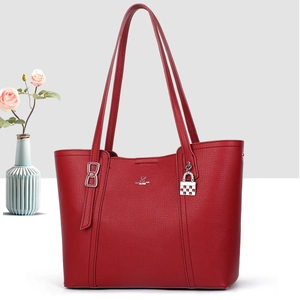 Detail of red pebbled leather tote with David Jones Paris logo and padlock charm