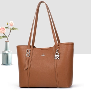 Detail of brown lychee texture leather tote with silver logo and plaid lock charm