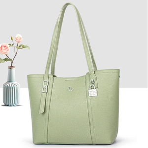 Elegant light green lychee leather tote bag for women with silver metallic pendant detail