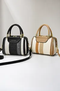 Two striped canvas handbags in black and brown with top-handles and gold-tone hardware.