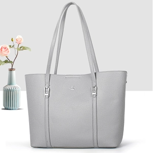 Detail of grey lychee grain leather tote bag with silver buckle and dual shoulder straps