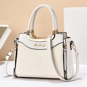 Elegant white leather handbag with woven texture detail and adjustable shoulder strap