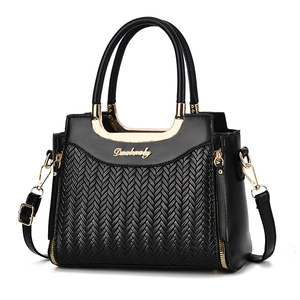 Black woven faux leather handbag for women featuring gold hardware and adjustable strap