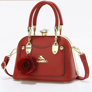 Elegant red faux leather handbag with golden cat logo and red rose pendant charm