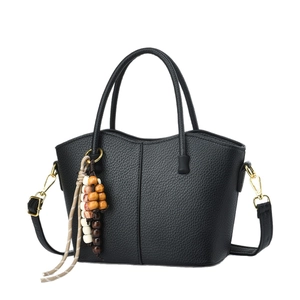 Retro black litchi leather bucket bag with gold hardware and beaded charm detail