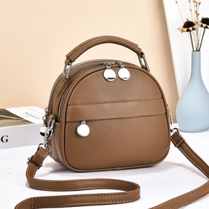 Brown litchi grain shell bag with double silver zippers and adjustable shoulder strap