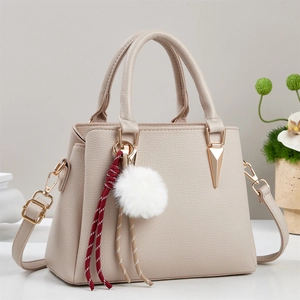Beige lychee textured tote bag with detachable strap and stylish plush charm