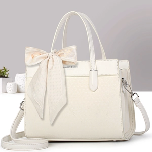 Chic off-white leather tote bag with woven texture and decorative silk bow accent