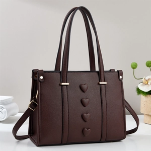 Deep coffee pebbled leather handbag with textured heart patterns and gold hardware details