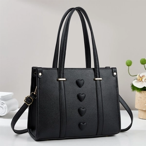 Fashionable black pebbled leather tote bag with heart embossed design and gold hardware