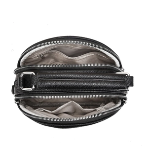 Top view of three zipper compartments in black pebble leather crossbody bag with gray lining