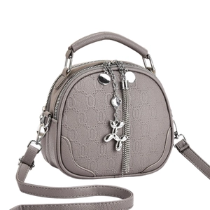 Gray-brown lychee leather crossbody bag with silver balloon dog charm and double zipper