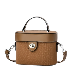 Brown box-shaped crossbody bag with top handle and textured woven detail on base