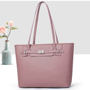 Detailed view of the dusty rose lychee grain tote bag with silver metal twist lock