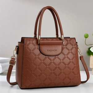 Brown litchi leather tote bag with geometric embossing and adjustable shoulder strap