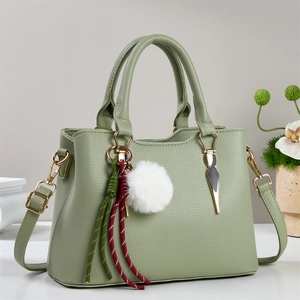 Chic light green lychee pattern leather tote bag with gold hardware and plush charm