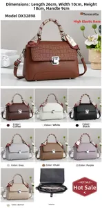 Detail view of stylish croc-texture handbag with silk scarf handle in 8 available colors