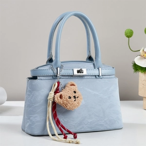 Light blue chic tote bag with marble texture, swivel lock and plush bear pendant detail