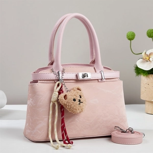 Pink marbled leather crossbody bag with teddy bear charm and adjustable shoulder strap