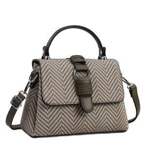 Green herringbone fabric crossbody bag with leather trim and adjustable shoulder strap
