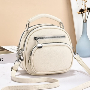 Cream white PU leather crossbody bag with multiple zippers and adjustable shoulder strap