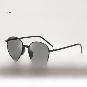 Macro shot of stylish oval metal sunglasses with black frames and dark lenses