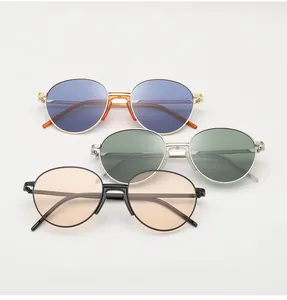 Oval metal sunglasses in gold, silver, and black frames with colored lenses detail