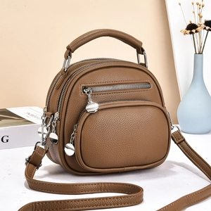 Brown multi-layer crossbody bag detail showing litchi grain texture and silver hardware