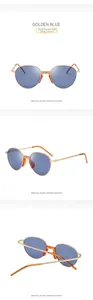 Detail view of golden oval sunglasses with blue lenses and textured metal temples