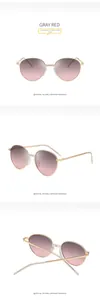 Three views of oval metal sunglasses featuring gray to red gradient lenses and gold frame