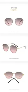Detail view of gold metal frames and gradient gray-red lenses of oversized sunglasses