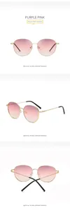 Detail of round gold metal frame sunglasses with purple pink gradient lenses and black tips