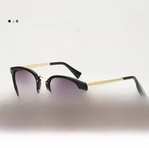 Detail of gradient purple lenses and gold metal temples on trendy cat-eye sunglasses