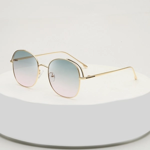 Women's oversized round metal sunglasses with green to purple gradient lenses