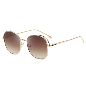 Fashionable oversized round sunglasses with gold metal frames and brown gradient lenses