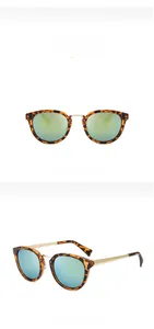 Detail view of tortoiseshell sunglasses with green mirror lenses and gold metal temples