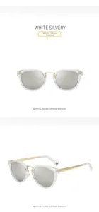 Detail of silver mirrored lenses and gold metal temples on clear jelly frame sunglasses