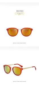Detail view of red translucent frame sunglasses with mercury lenses and gold metal temples