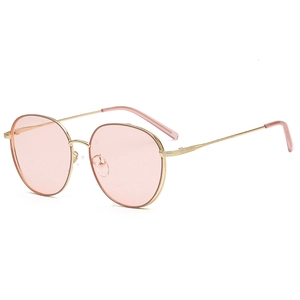 Retro round fashion sunglasses with golden metal frame and pink translucent lenses