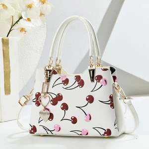 Elegant white litchi leather handbag with cherry print and golden heart charm