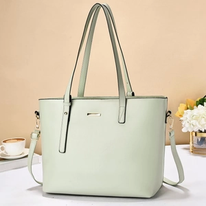 Elegant mint green tote bag for women with gold hardware and adjustable strap