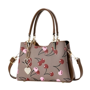 Brown cherry print tote bag with gold heart charm and adjustable shoulder strap
