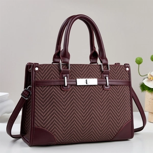 Elegant burgundy herringbone textured handbag with silver twist lock and smooth top handles