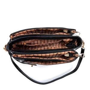 Internal view of black patent leather crossbody bag with multiple zippered compartments