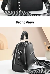 Front view of black pebble leather crossbody bag with wide patterned strap and stud details