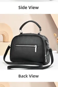 Detail of black litchi texture leather crossbody bag with silver metal zipper accents